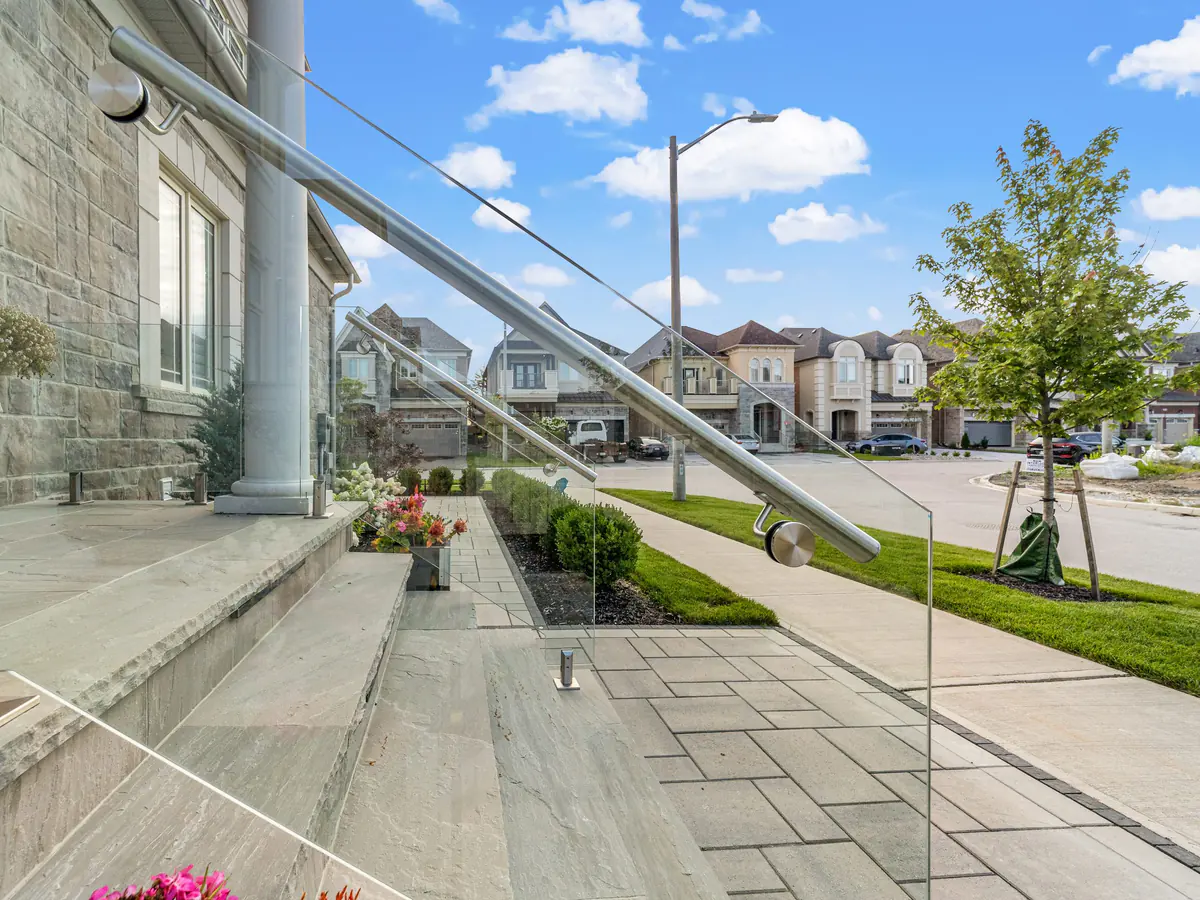 Glass guard with a stainless rail running down a front walkway
