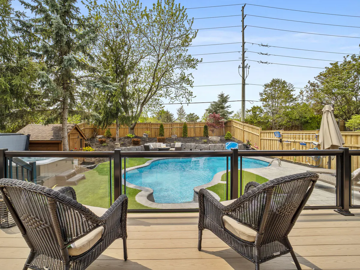 Framed glass guard overlooking a backyard pool